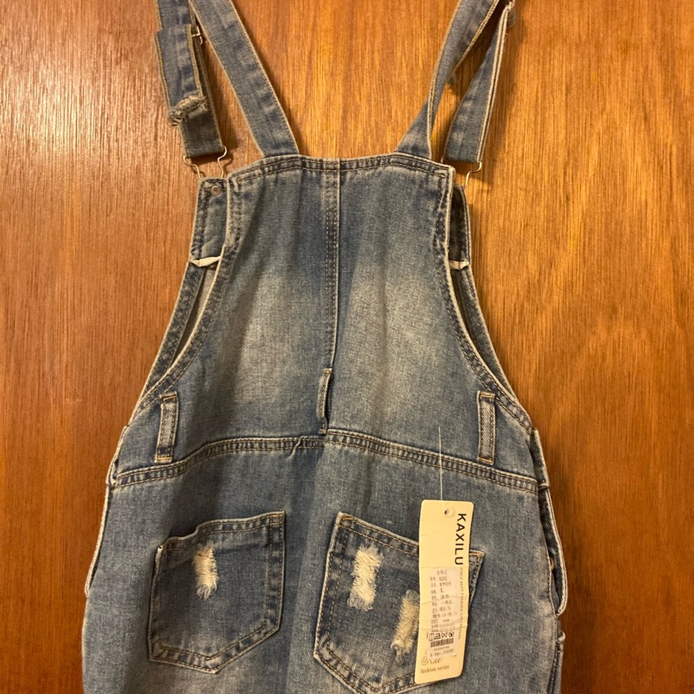 Girls Jean short overalls. Distressed with adjustable straps and stud buttons
